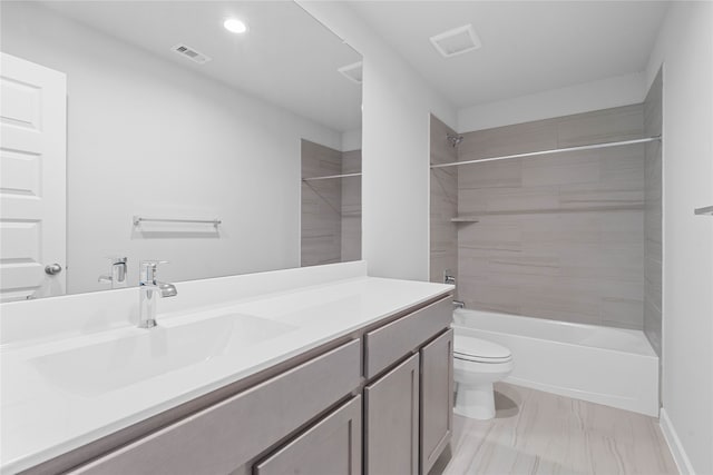 full bathroom with vanity, toilet, and tiled shower / bath combo