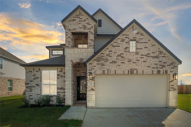 view of front of home featuring a garage and a lawn