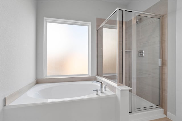 bathroom with shower with separate bathtub