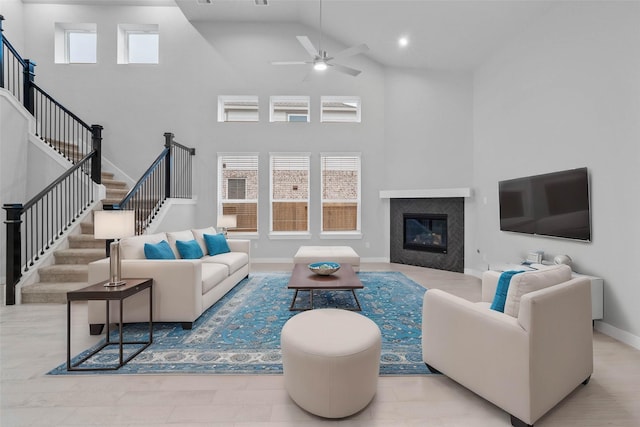 living room featuring a towering ceiling and ceiling fan