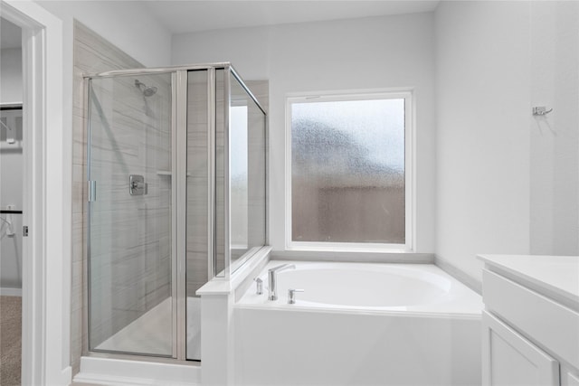 bathroom featuring vanity and shower with separate bathtub