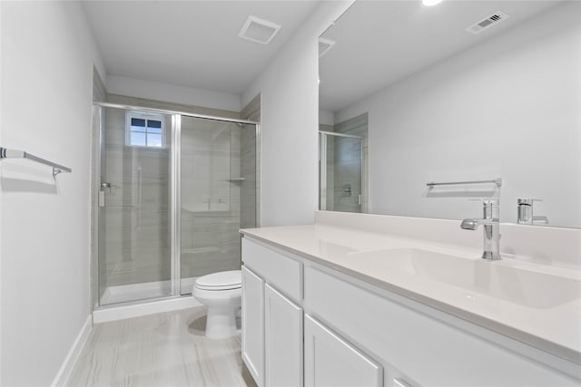 bathroom with a shower with door, vanity, and toilet