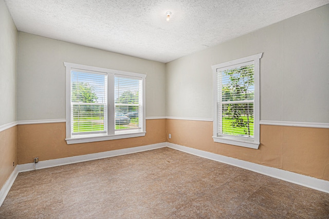 empty room featuring a textured ceiling