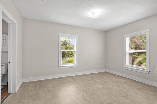 7506 2nd St, Hitchcock, TX 77563 - empty room featuring baseboards and a healthy amount of sunlight
