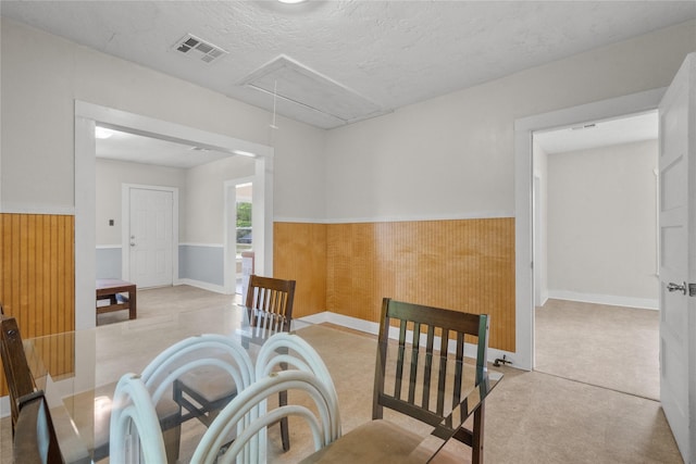 7506 2nd St, Hitchcock, TX 77563 - dining space with carpet flooring, visible vents, attic access, and a wainscoted wall
