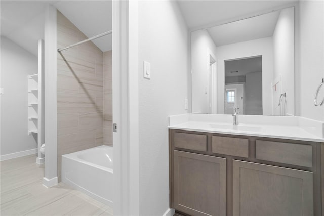 full bathroom featuring vanity, toilet, and tiled shower / bath combo