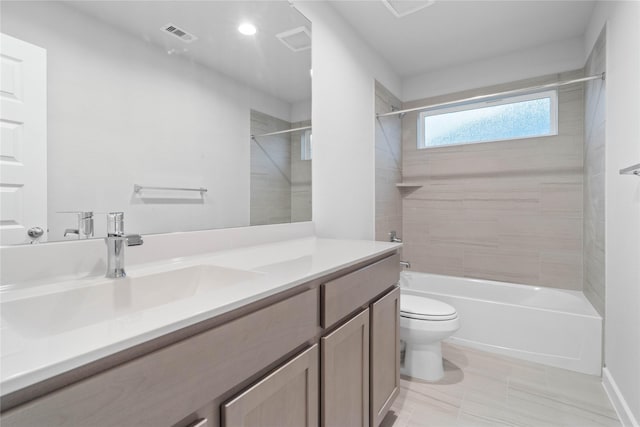 full bathroom featuring vanity, toilet, and tiled shower / bath combo