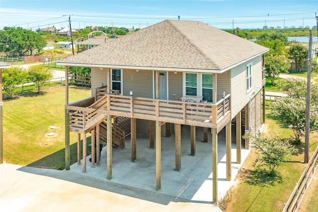 rear view of house featuring a yard