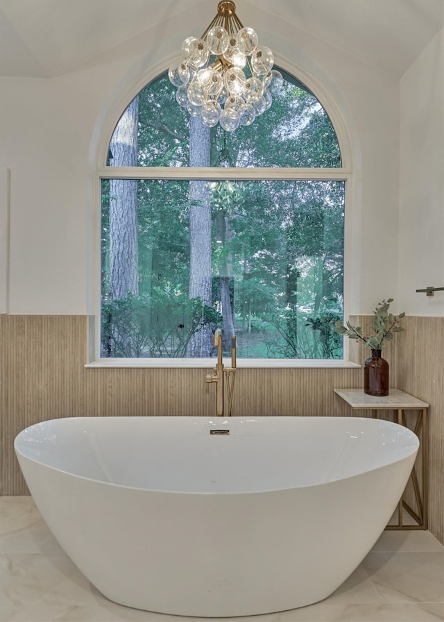 bathroom with an inviting chandelier and tile patterned floors