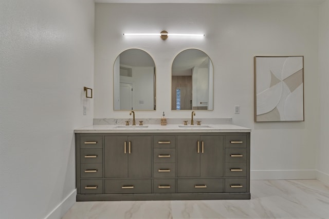 bathroom with dual bowl vanity and tile patterned flooring