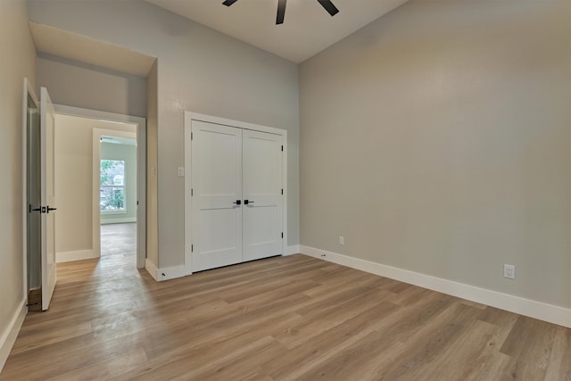 unfurnished bedroom featuring ceiling fan, a closet, and light hardwood / wood-style floors