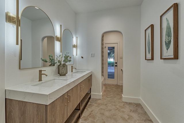 bathroom with double vanity and tile patterned floors