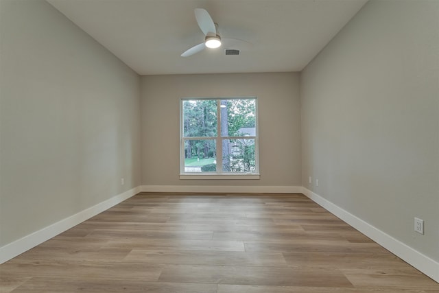 spare room featuring light hardwood / wood-style floors and ceiling fan