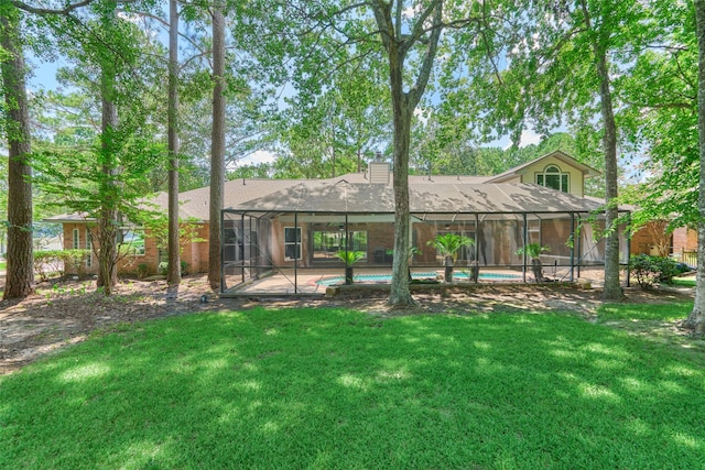 rear view of house featuring a lanai, a patio, and a yard