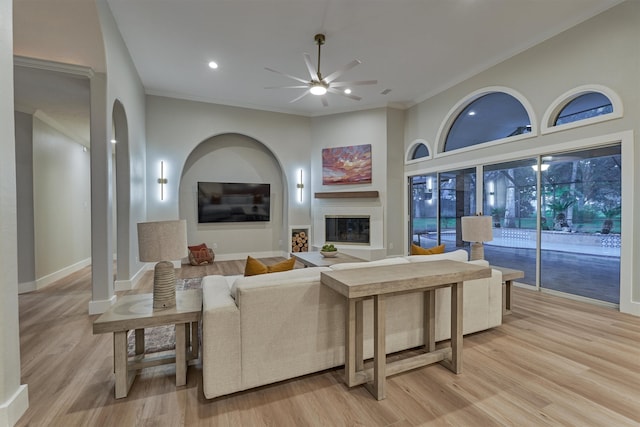 living room featuring ceiling fan, light hardwood / wood-style flooring, and ornamental molding