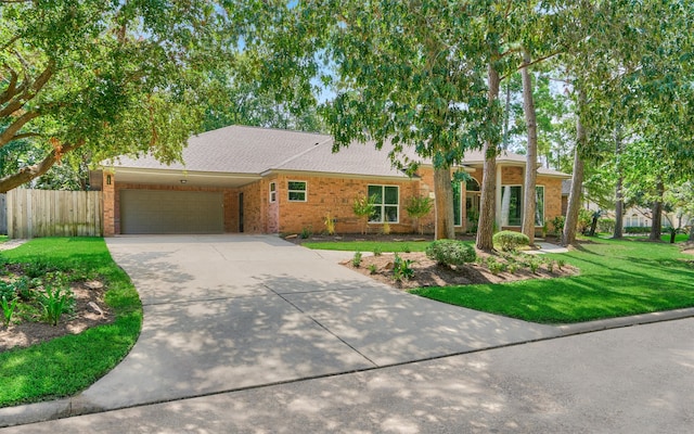 ranch-style home with a garage and a front yard