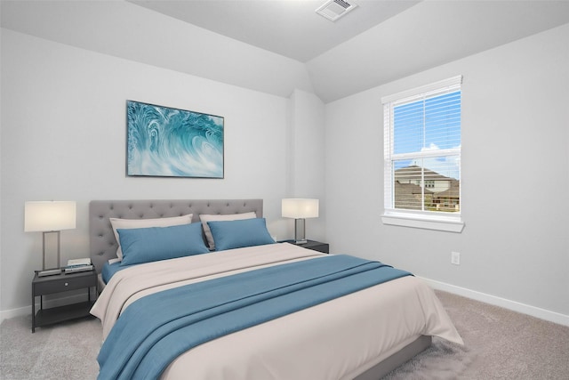 bedroom featuring vaulted ceiling and light carpet