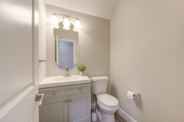 bathroom featuring toilet and vanity