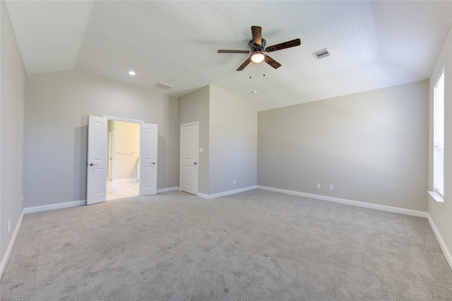 unfurnished bedroom featuring lofted ceiling, light colored carpet, and ceiling fan