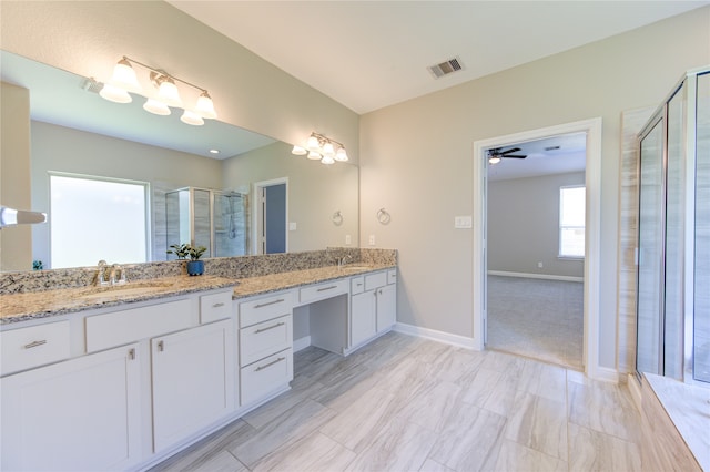 bathroom with ceiling fan, an enclosed shower, and vanity