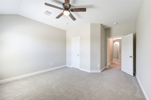 unfurnished bedroom with ceiling fan, light colored carpet, and lofted ceiling