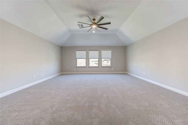 carpeted spare room with vaulted ceiling and ceiling fan