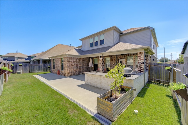 view of front of home with a patio area and a front yard