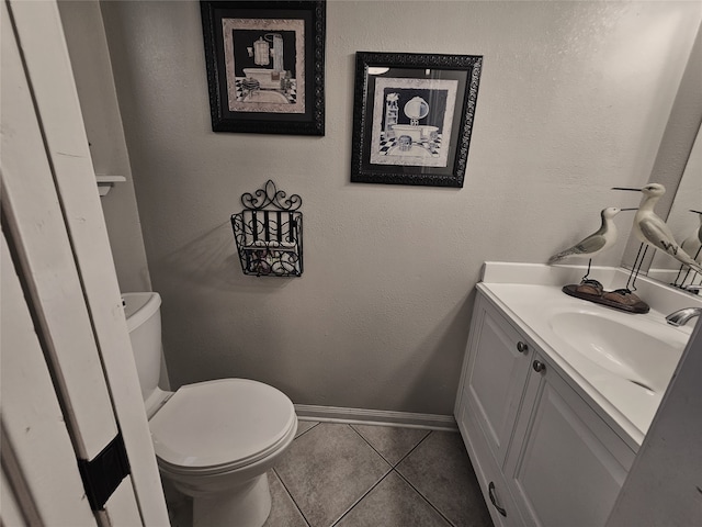 bathroom with tile patterned floors, toilet, and vanity