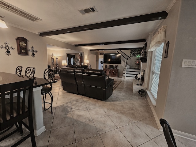 living room with light tile patterned floors and beam ceiling