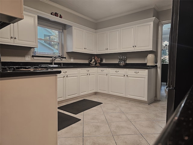 kitchen with white cabinetry, light tile patterned floors, and ornamental molding