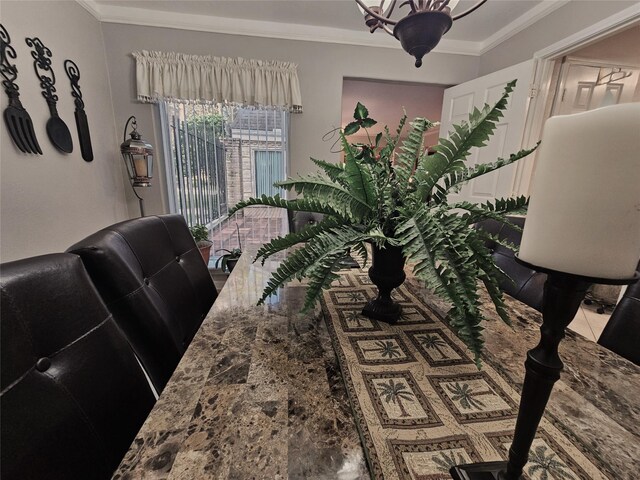 tiled dining room featuring ornamental molding