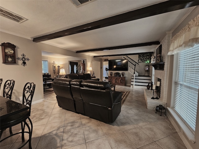 tiled living room with beam ceiling, ornamental molding, and a fireplace