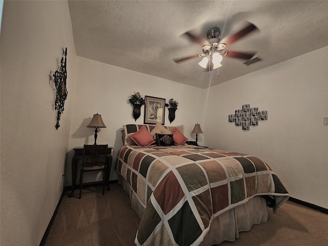 carpeted bedroom with ceiling fan and a textured ceiling