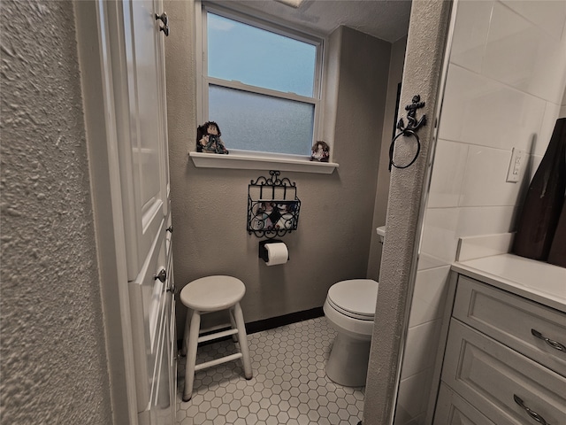 bathroom with tile patterned floors, vanity, and toilet