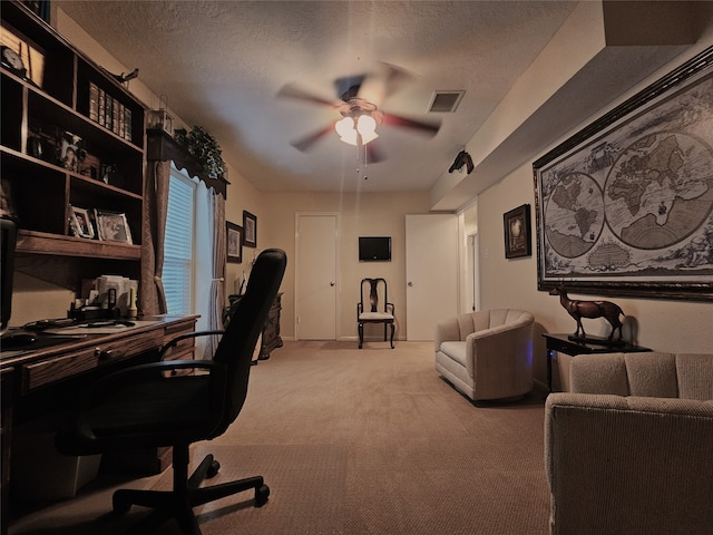 office space with ceiling fan, light carpet, and a textured ceiling