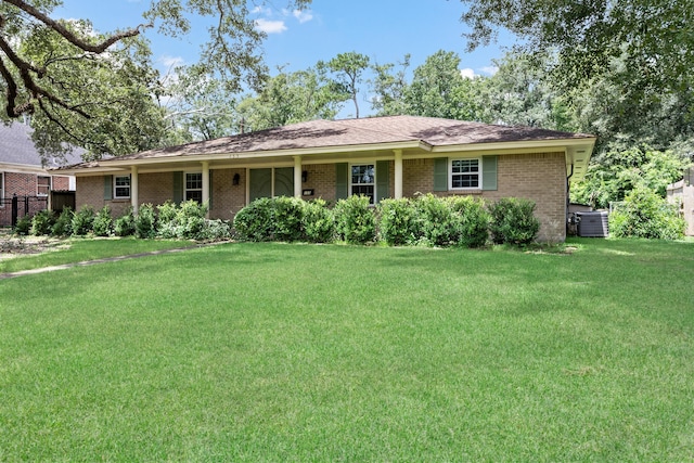 ranch-style home with central AC unit and a front yard