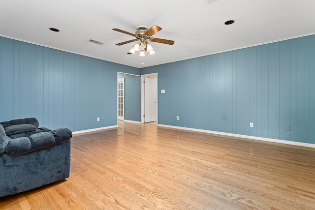 interior space featuring light hardwood / wood-style floors, crown molding, and ceiling fan