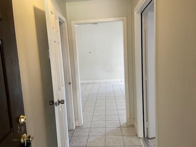 hallway with light tile patterned flooring