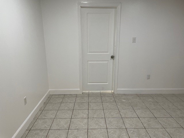 unfurnished room with light tile patterned floors