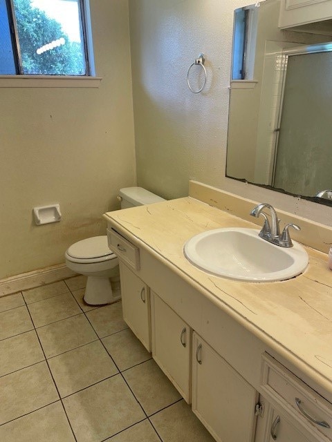 bathroom featuring tile patterned floors, toilet, and vanity