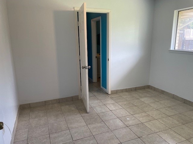 empty room featuring light tile patterned floors