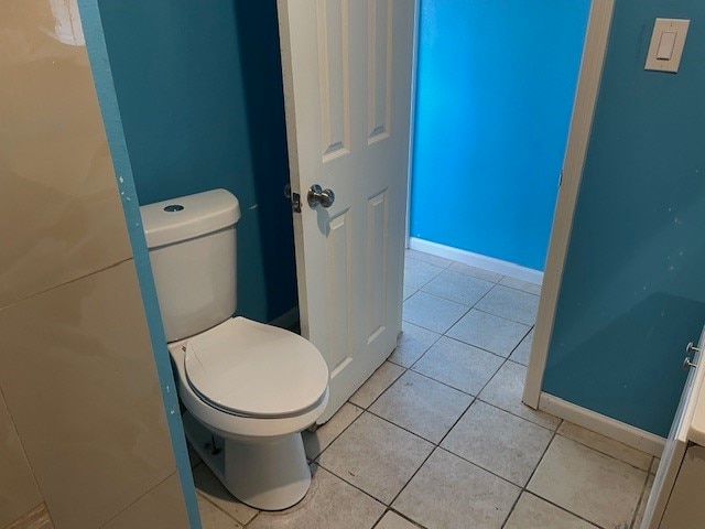 bathroom featuring tile patterned flooring and toilet