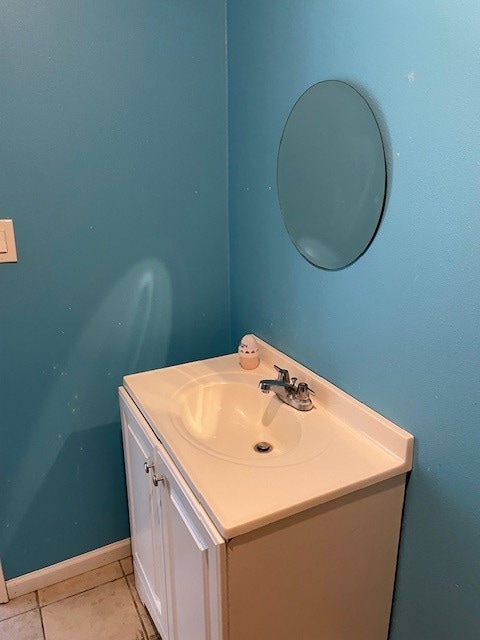 bathroom featuring tile patterned flooring and vanity