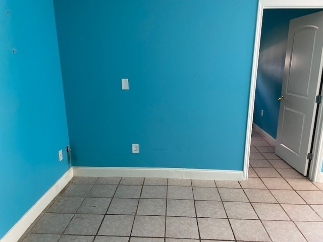 spare room with light tile patterned floors