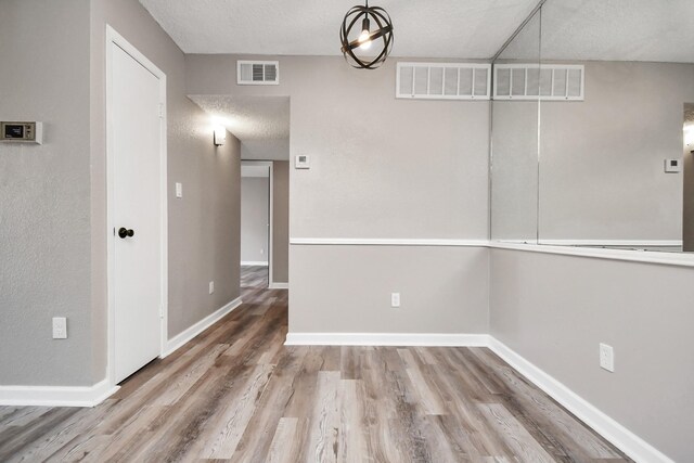 empty room with hardwood / wood-style floors