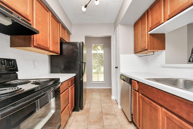 kitchen with backsplash, dishwasher, black range with electric stovetop, light tile patterned flooring, and a textured ceiling