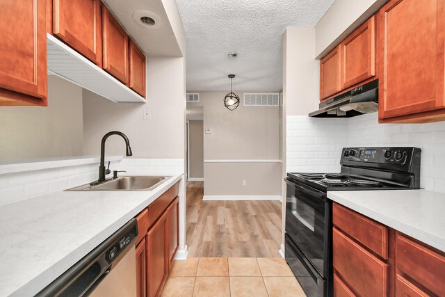 kitchen with backsplash, light hardwood / wood-style floors, sink, pendant lighting, and black range with electric cooktop