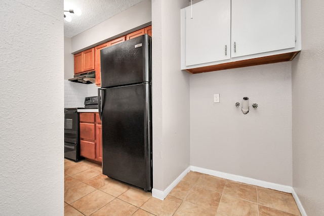 kitchen featuring a textured ceiling, black appliances, light tile patterned floors, and decorative backsplash