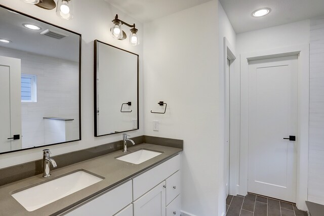 bathroom featuring tile patterned flooring and double vanity