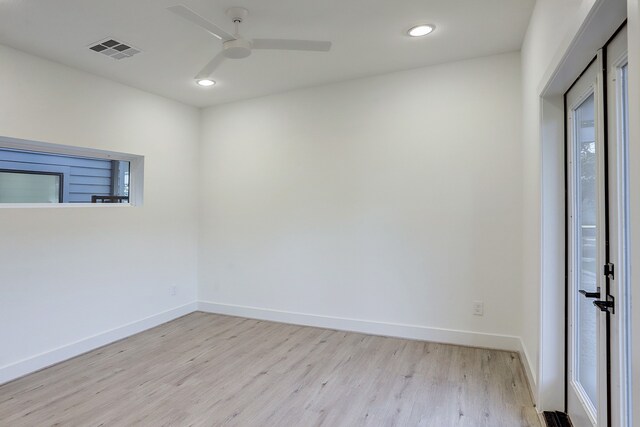 unfurnished room with ceiling fan and light hardwood / wood-style floors